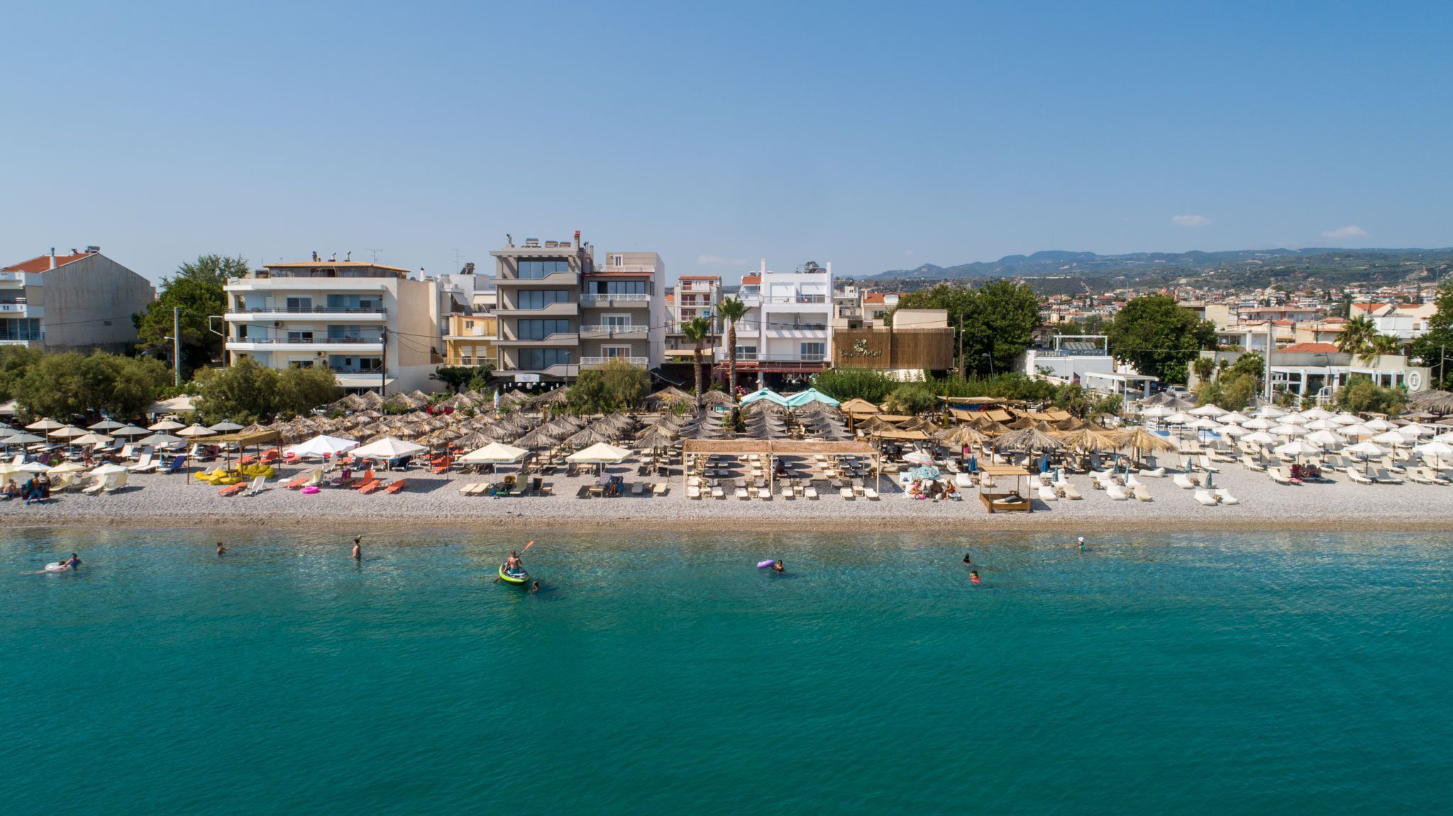 Kiato and Vrachati: Coastal Corinthia by Train from Athens 1 Kiato organised beach with umbrellas and turquoise water