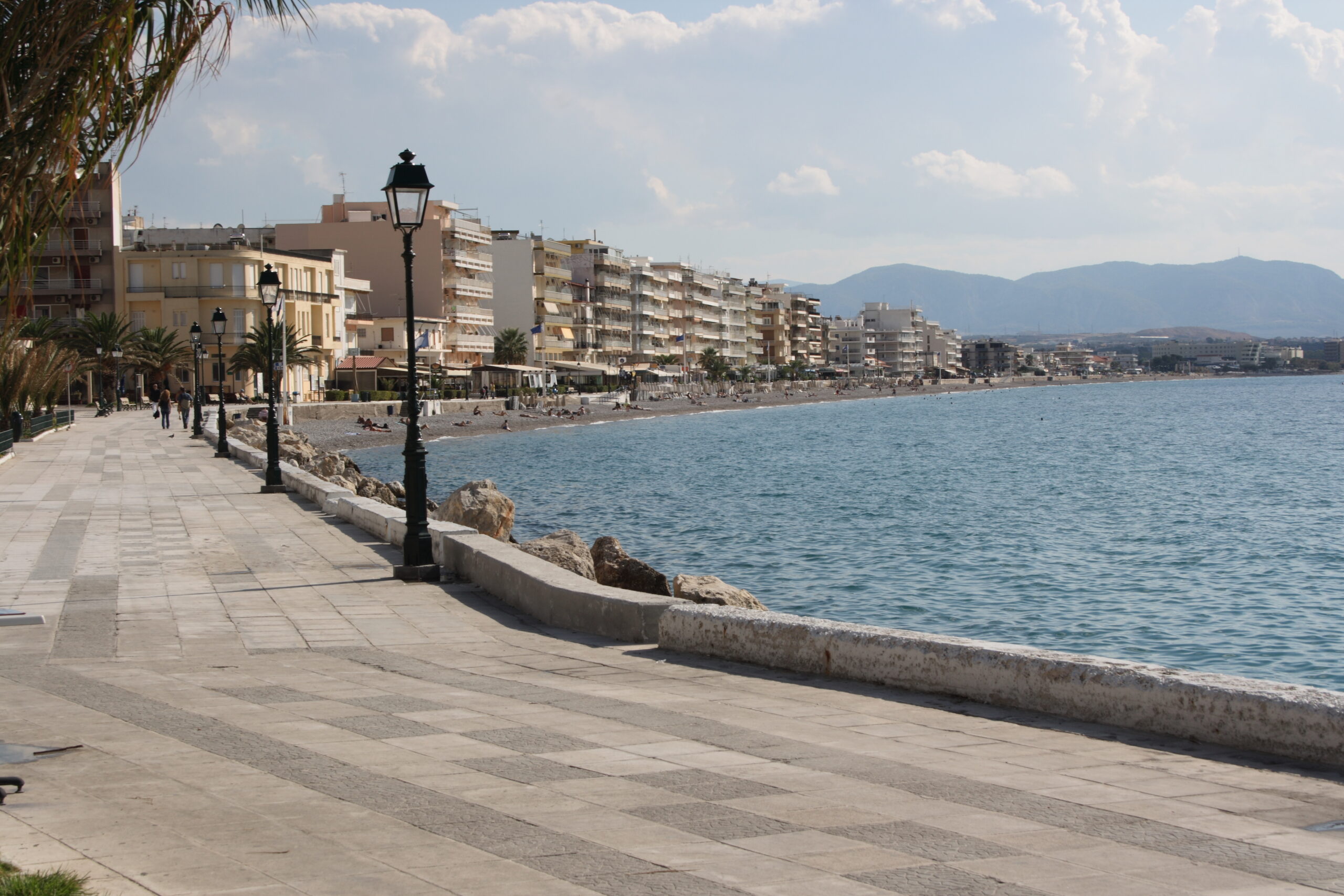 Loutraki Wellness Guide: Thermal Springs, Spas & Relaxation 1 The Loutraki seafront promenade with palm trees and the beach